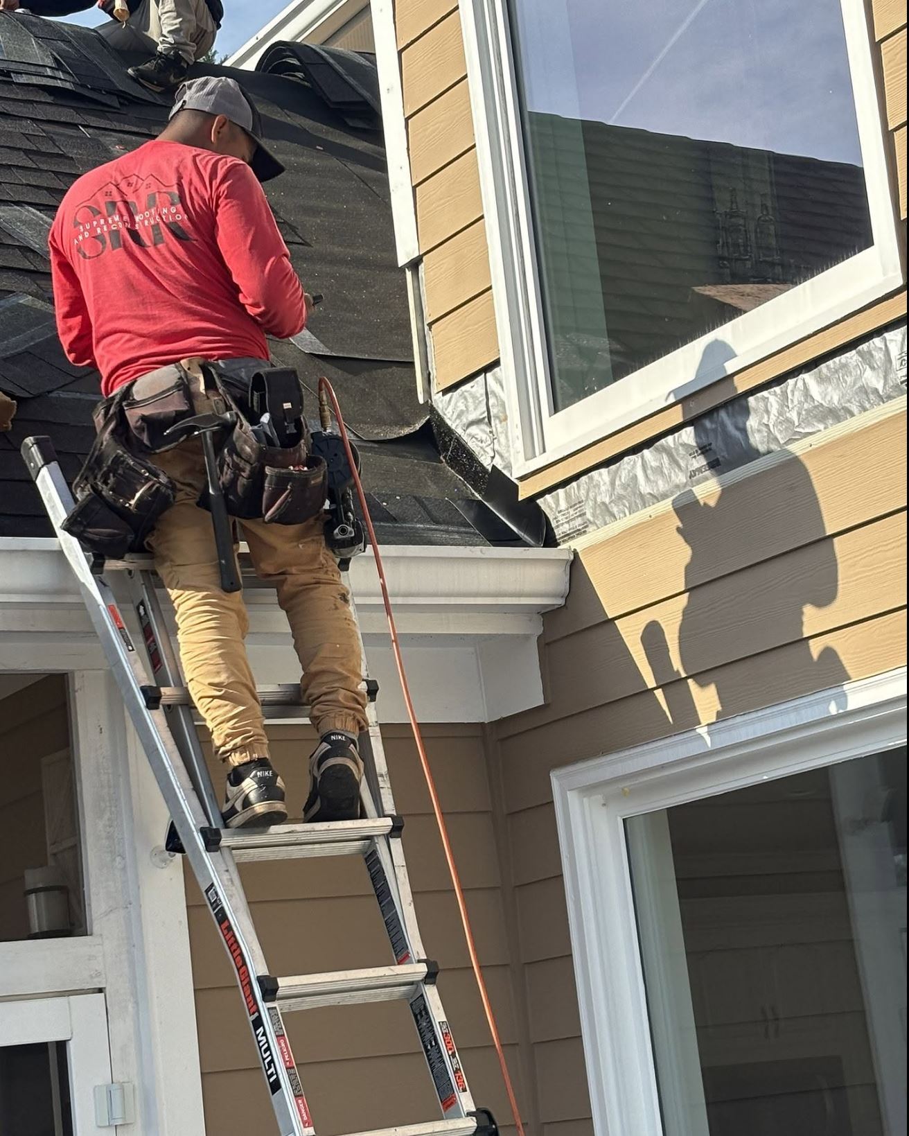 Supreme Roofing crew installing gutters in Aragon, Polk County GA
